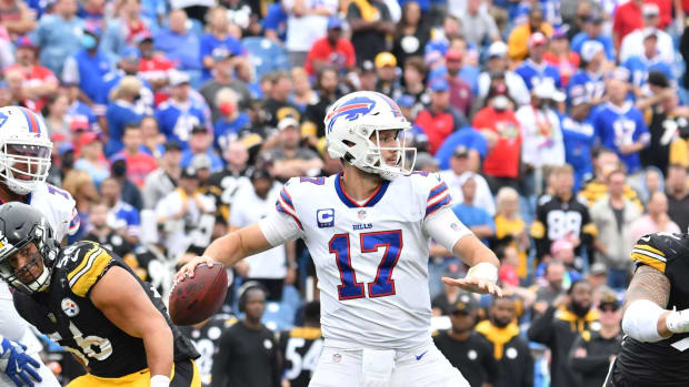 Buffalo Bills quarterback Josh Allen (17) throws a pass under pressure from Pittsburgh Steelers linebacker Alex Highsmith (56) and defensive end Tyson Alualu (94).